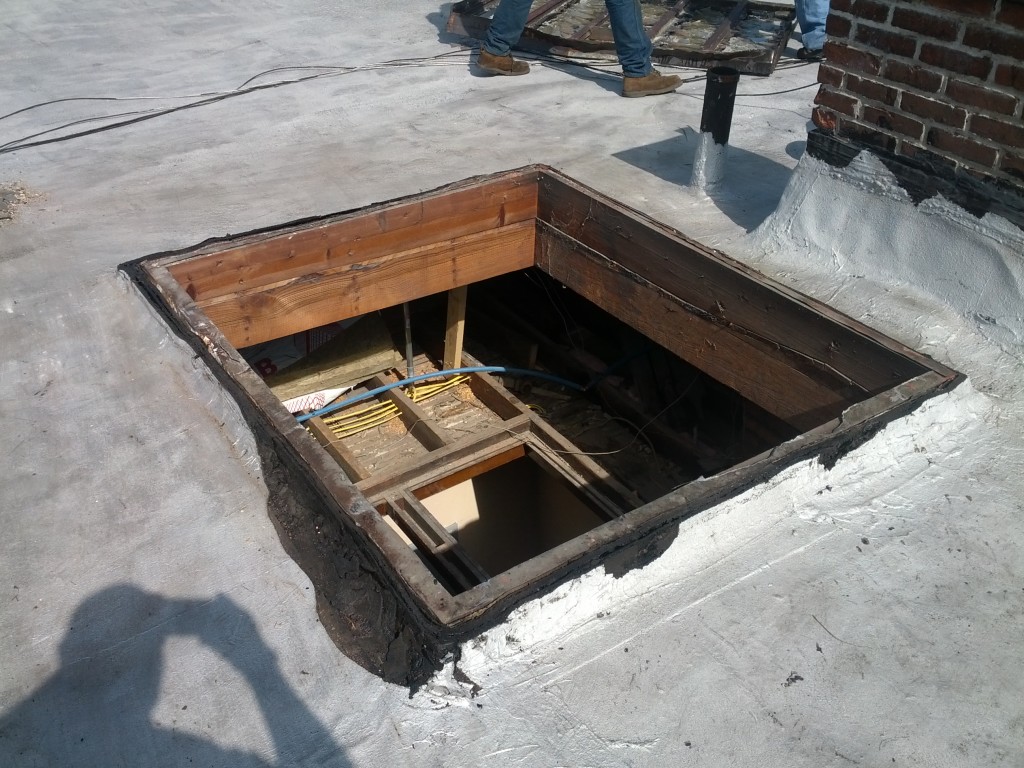 Reader roofing installing a skylight on a commercial building.