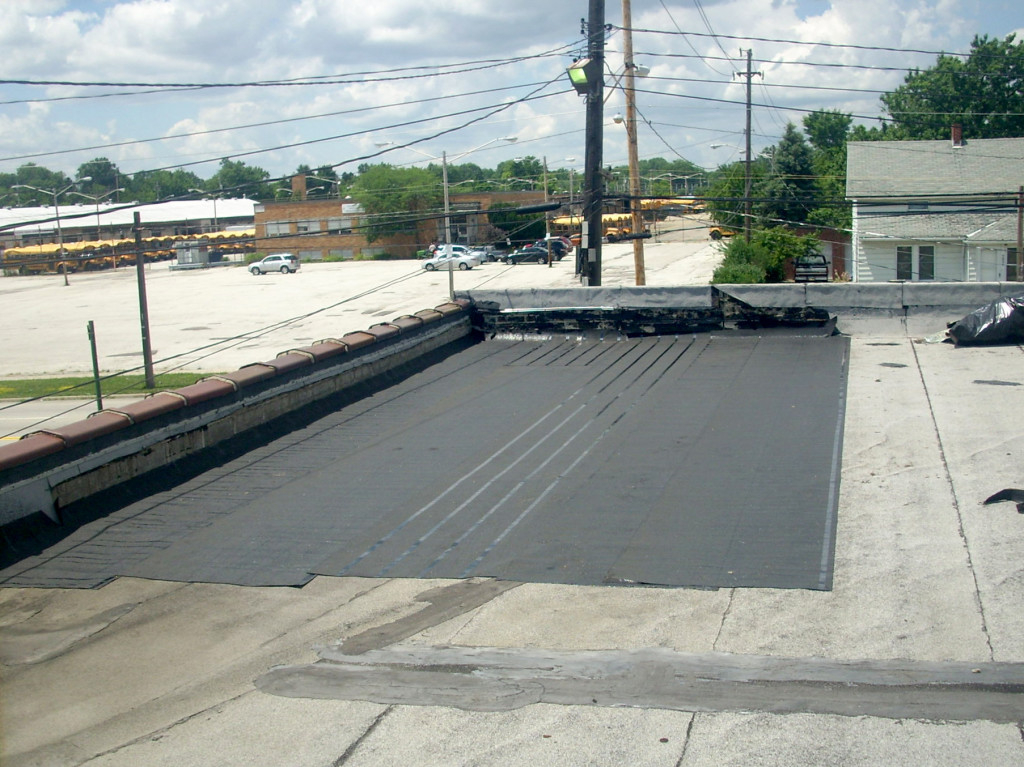 Roofing team then installed the first layer of modified bitumen.